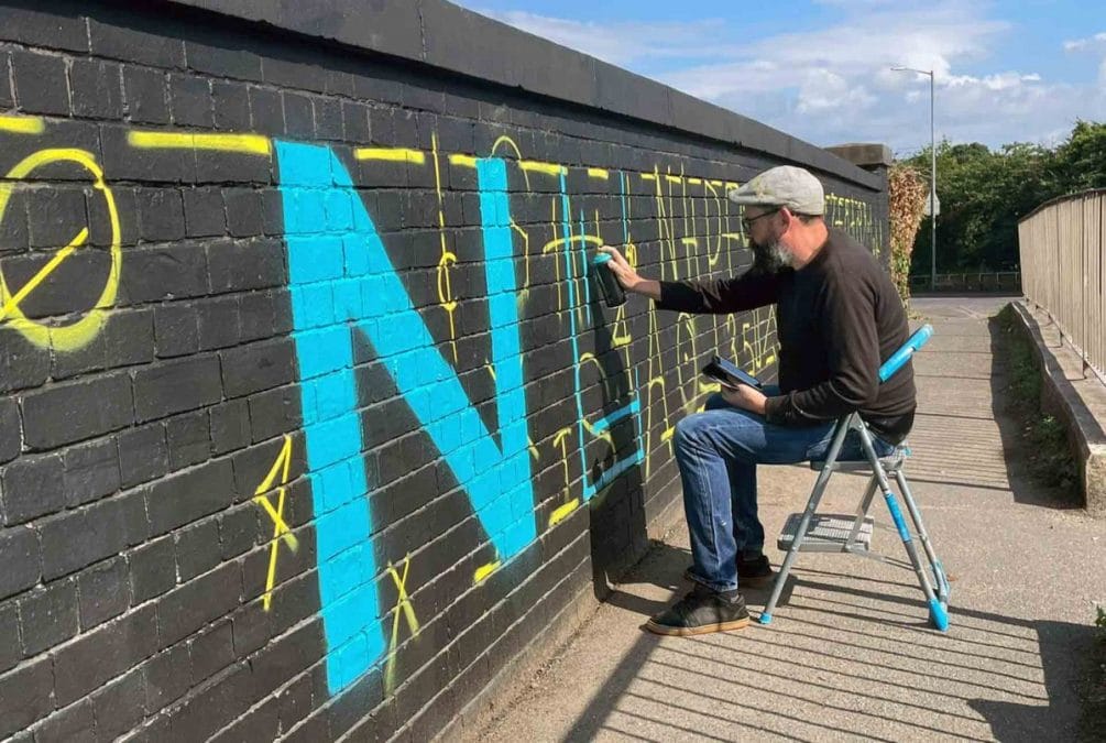 Volunteers work with street artist to revamp railway bridge in Netherfield covered with graffiti